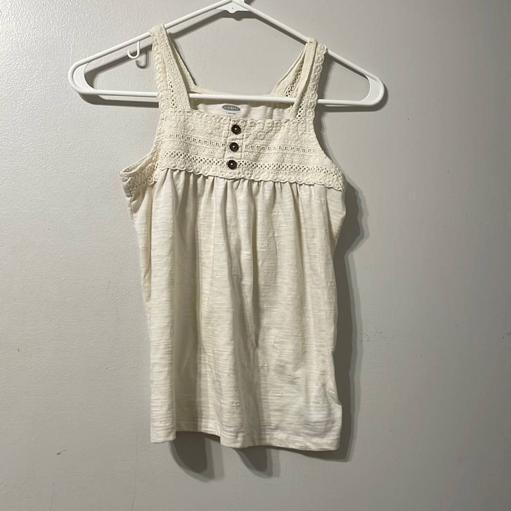 Top has a lace over it. And three buttons.